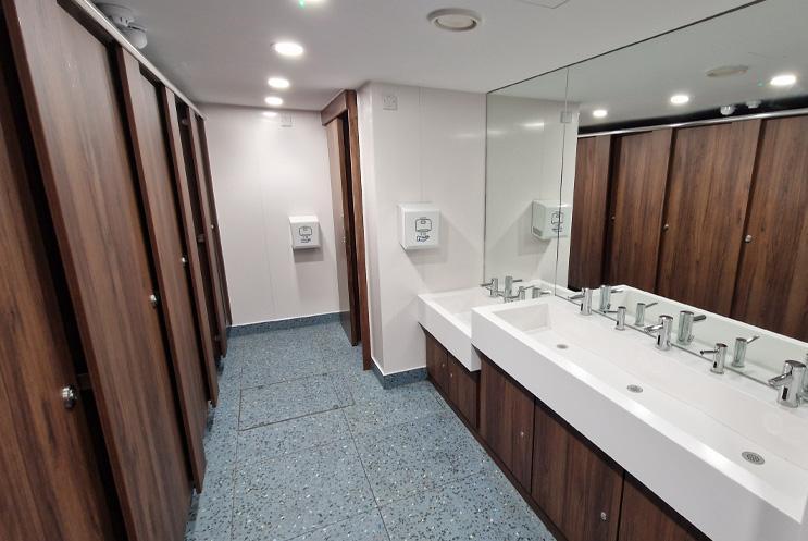 A view of the sinks and cubicles in the women's toilets