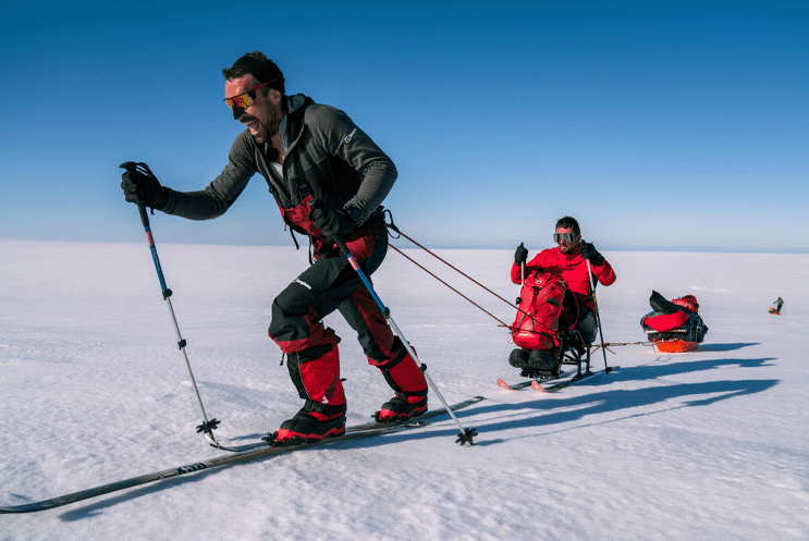 People skiing across a frozen landscape