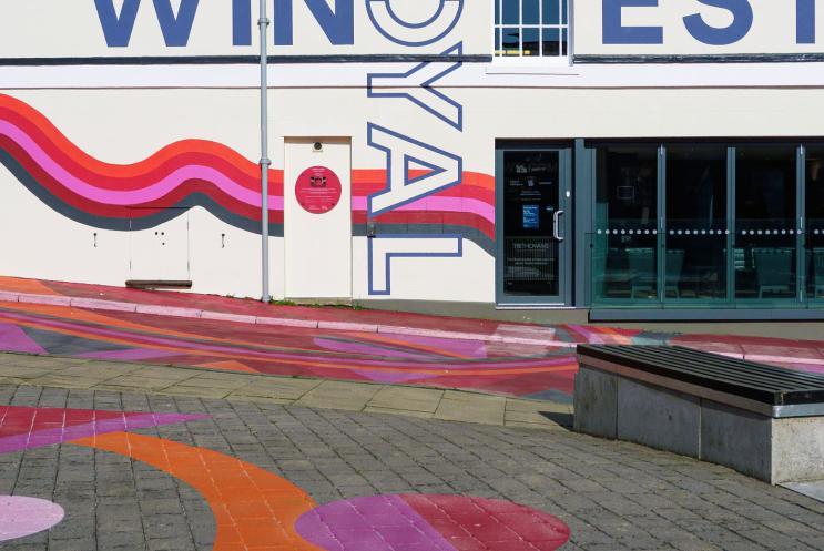 Colourful artwork on the street outside Theatre Royal Winchester