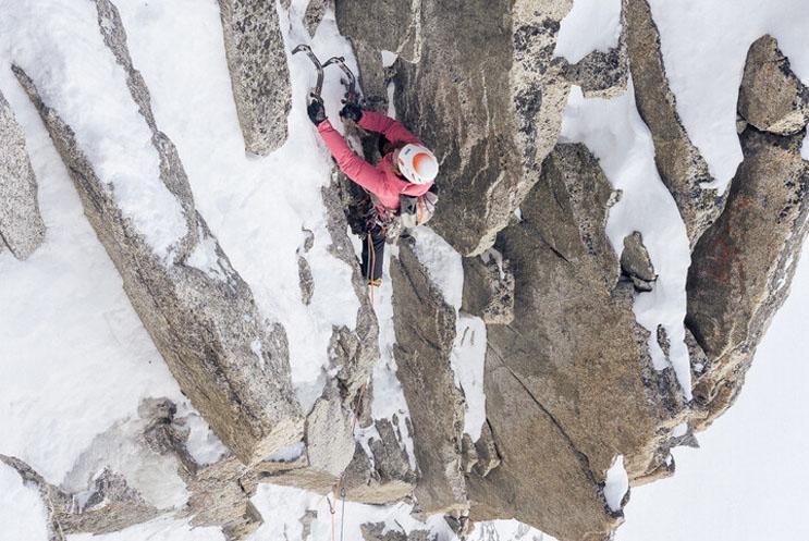 A person climbing a snowy mountain.