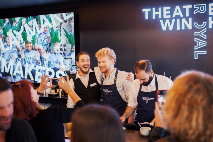 Smiling people working in a cafe.