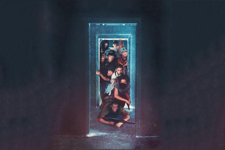 A number of people squeezing through a doorway