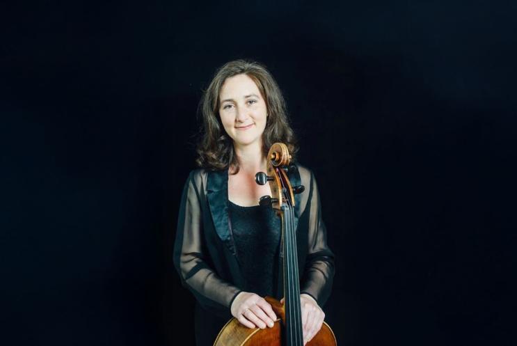 A person holding a cello