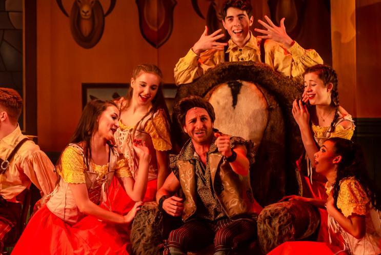 handsome panto man surrounded by flirtatious women