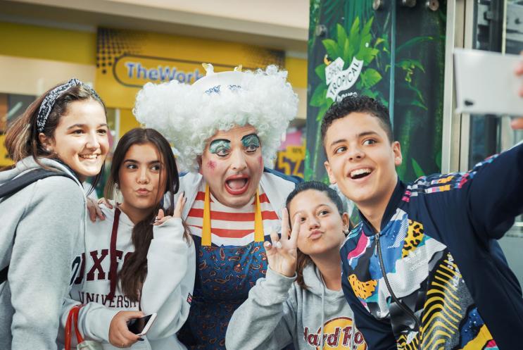 Children taking selfie with a pantomime Dame