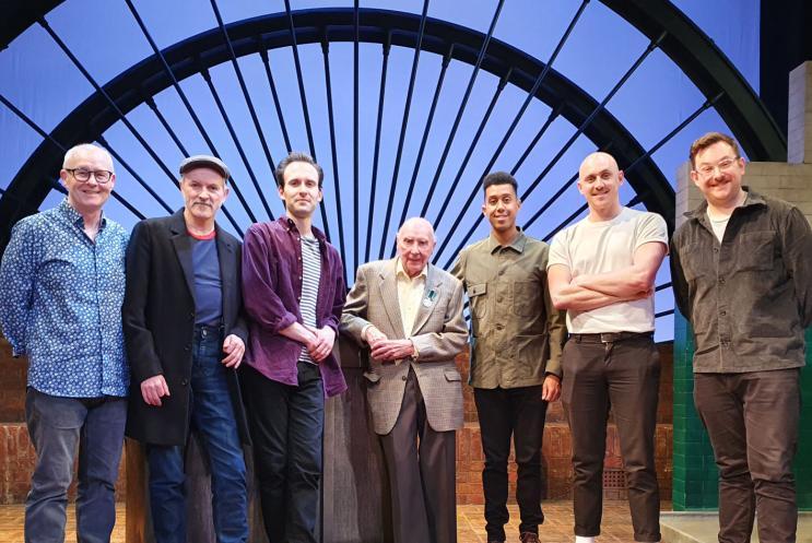 Phil Yates with The Glee Club cast on stage