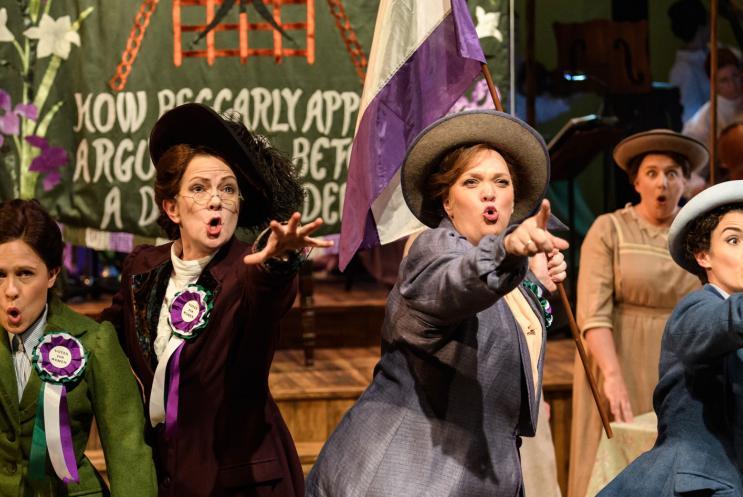 Suffragette characters from the opera, Rhondda rips it up, pointing out to the audience.
