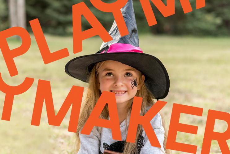A young girl in a witch hat