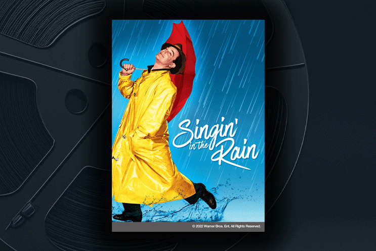 Movie poster for Singin' in the Rain. A man in a yellow raincoat holding a red umbrella.
