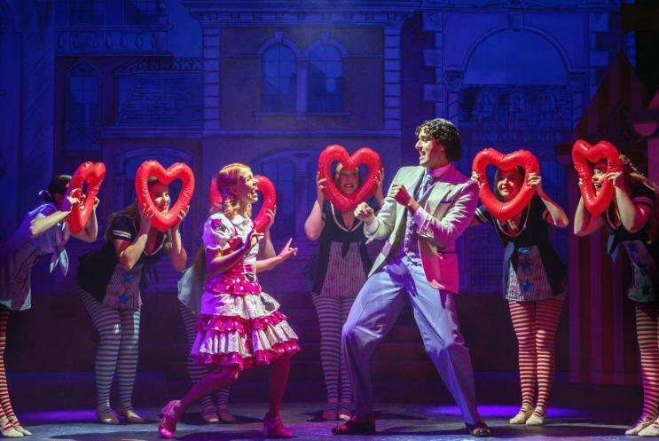 A panto cast performing on stage