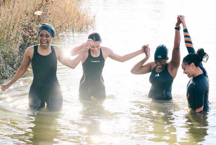 Women celebrating and standing in water