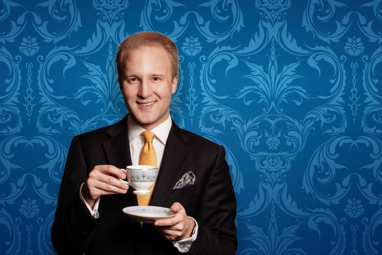 William Hanson holding a teacup and saucer