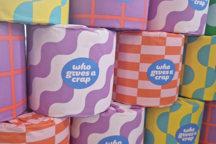 A display of colourful Give a Crap toilet rolls