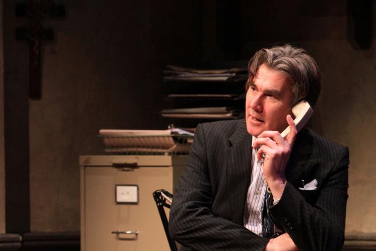 Man using the phone sat in an office